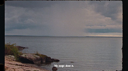 still from On and On and On by Evelyn Pakinewatik, depicting a body of water with the words 'no escape about it'
