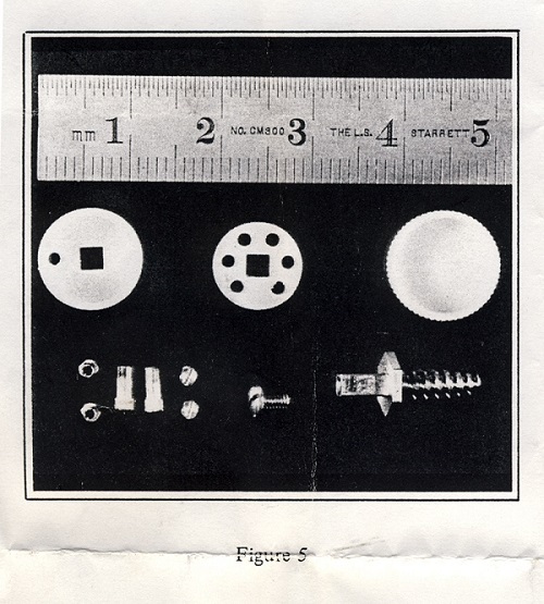 There is a single image that was selected to represent the exhibition. The image is from artist Darrin Martin’s project “Listening In…” and is a detail from his multichannel work.  The photograph is black and white. It is rectangular. It is an archival image which is suggested by the creased edges and the note at the bottom that says “Figure 5”. Above the text “Figure 5” is a photograph of a ruler—the first 5 inches of the ruler is included to show the relative size of the items below it: they appear to be made of metal and they are 3 circular items, one is 1 inch and has two holes in it, the central circle is 8 millimeters and has one square hole in the centre of it and 6 round holes around the edges of it. The third circle has no holes, but it has perforations on the edges. Below the first circle are 2 screws, each are 2 millimeters wide and 4 washers that are also 2 millimeters wide. Below the second circle is a screw that is 4 millimeters wide and below the final circle is 1.5 inches wide.  The curator selected this image, which depicts materials used in early cochlear implant procedures because it is suggests that hearing is not always readily accessible.