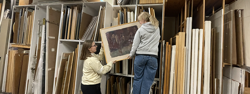 Collections assistant Emily and collections volunteer Kath in McIntosh Gallery's collection storage vault